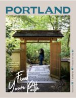 cover of Travel Portland's visitor guide, 2019-'20, featuring a woman walking through Portland Japanese Garden